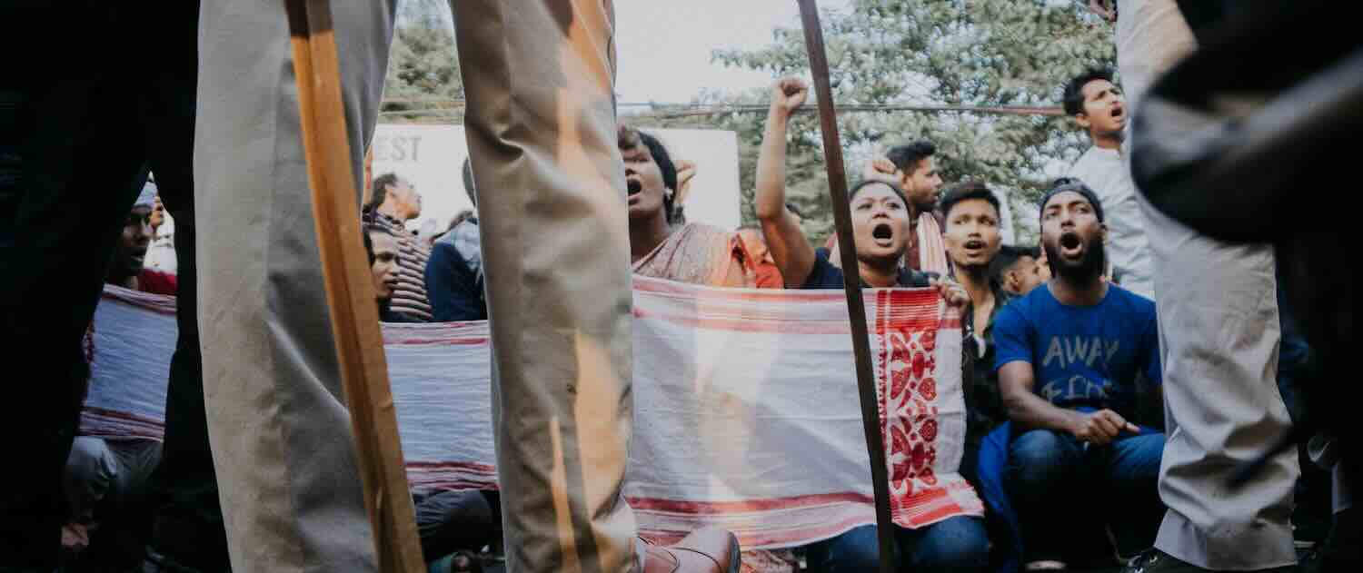 Photo of people of Assam protesting before the police during the CAA protest at Guwahati, Assam
